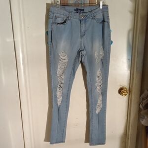 Woman's very distressed jeans, good stretch. Size 11 blue.